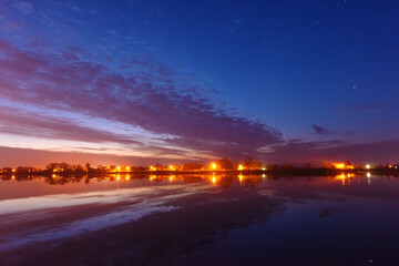 Wall Mural - a magical starry night on the river bank with a large tree and a milky way in the sky and falling st