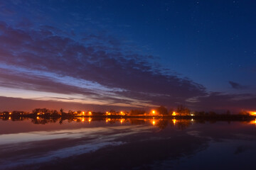Wall Mural - a magical starry night on the river bank with a large tree and a milky way in the sky and falling st