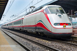 Fototapeta Paryż - The train stops near the platform station in Italy