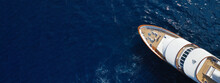 Aerial Drone Ultra Wide Photo Of Luxury Yacht With Wooden Deck Anchored In Mediterranean Deep Blue Sea, Greece