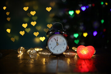 Sticker - New year composition with an alarm clock and beautiful bokeh in the background.