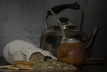 Shot Of A Brown Calabash, A Kettle And A Bag Filled With Tea Herb Called Mate