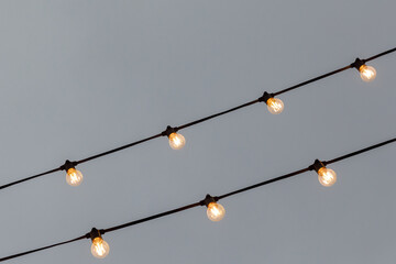 light bulb garlands against the grey sky