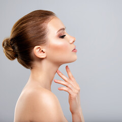 portrait of the beautiful woman who touches the neck by fingers - isolated.