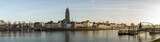 Fototapeta Boho - Super wide cityscape panorama of the Dutch Hanseatic medieval city of Deventer in The Netherlands seen from the other side of the river IJssel at sunrise