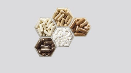 Wall Mural - Various pills and capsules in hexagonal jars appear on a grey background