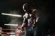 © DmitryStock - Emotional strong bare-chested African American man sprays magnesium or talcum powder and screams. Heavyweight man preparing for the competition