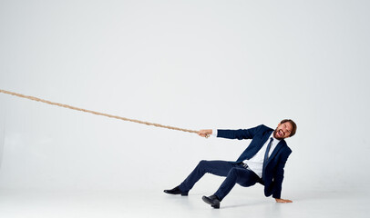 Poster - man with rope in hand on light background business finance 