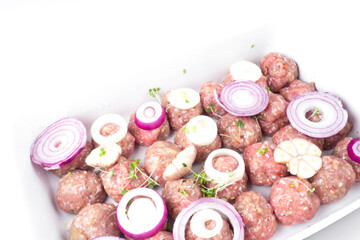 Wall Mural - raw meat balls with vegetables and microgreens isolated on white