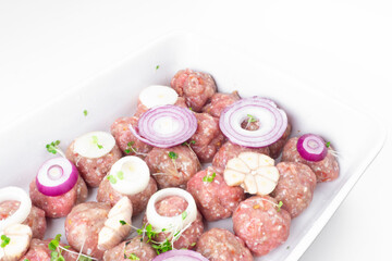 Wall Mural - raw meat balls with vegetables and microgreens isolated on white