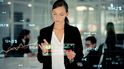 Cheerful young businesswoman uses a holographic tablet. Young startup founder stands on a background of holographic graphs and tables at office room. Business and technology concept. Smart office