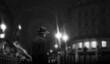 the dark silhouette of a male hat in a night street light.
