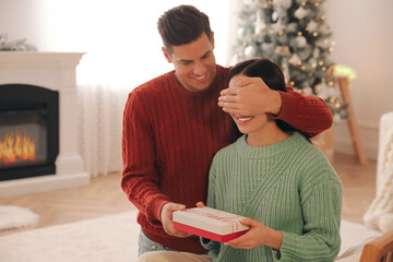 Poster - Boyfriend giving Christmas gift box to his girlfriend at home