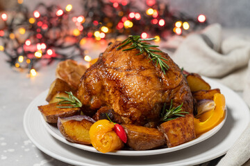 Christmas chicken baked with potatoes yellow peppers and rosemary. Christmas dinner, festive holiday dish.