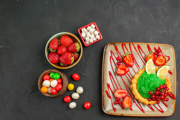 top view delicious cake with candies on dark floor sweet sugar dessert tea