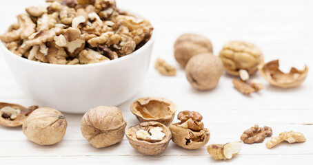 Canvas Print - walnuts in  white plate on  white wooden table