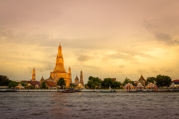 Wat Arun temple at sunset time in on Chao Phraya River Bangkok, Thailand. Important landmarks are symbols