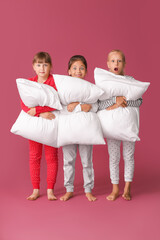 Wall Mural - Emotional little girls with pillows on color background