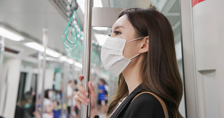 Wall Mural - woman with mask in metro