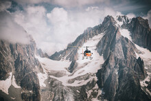 Helicopter Flying Over Mountains In The Alps