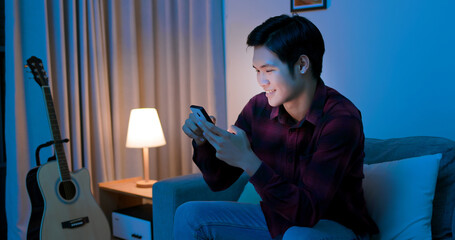 man use smart phone happily