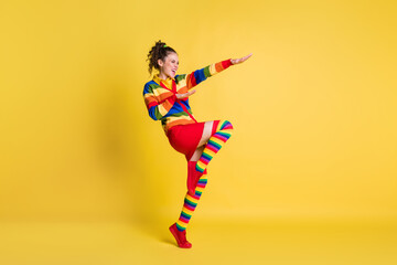 Wall Mural - Full body photo of funky lady dance youth moves wear striped sweater skirt knee socks shoes isolated yellow color background