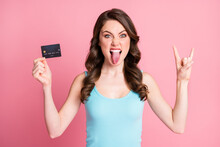 Photo Of Funky Cool Lady Hold Card Show Rock Sign Tongue Out Wear Blue Top Isolated Over Pastel Pink Color Background