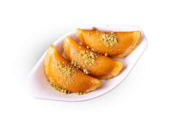 Qatayef Ramadan Or katayef Traditional Sweets cheese and brown Cinnamon sticks on white dish
