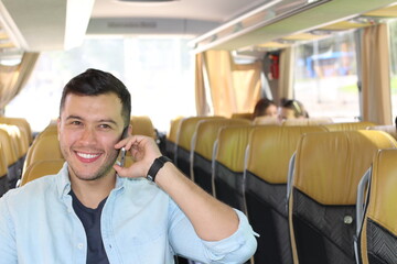 Ethnic man using cellphone on the bus 