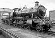Steam engine on a railway track. Industrial revolution heritage.