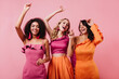 © Look! - Excited girls in bright outfit expressing happiness. Latin woman spending time with friends.