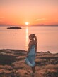 © Anas - Woman on a hill watching the sunset over the ocean