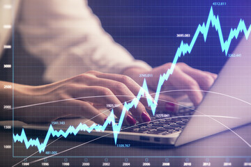 Double exposure of businesswoman hands typing on computer and forex chart hologram drawing. Financial analysis concept.