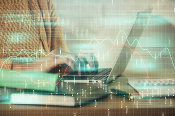 Double exposure of woman hands typing on computer and forex chart hologram drawing. Stock market analysis concept.