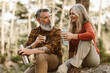 © Criene Images - portrait of senior couple drinking water and resting from hike outdoors