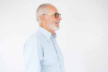 Closeup profile view of senior bearded man over white background.