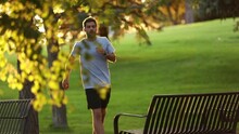 Man Catching His Breath While Jogging And Stopping In A Park.