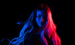 © loran4a - Portrait of fashion young girl in red and blue neon light in the studio.