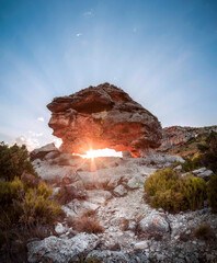 Wall Mural - Stone Megalithic monument. A beautiful sunset where the sun's rays pierce the center of a Neolithic monument. Astronomical marker of the Iberian people. Sunset in a Neolithic dolmen.