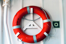 A Life Preserver Hanging On The Deck Of A Ship.