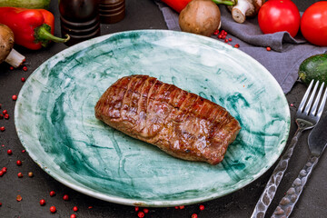 Wall Mural - roast beef Steak with green on black concrete table