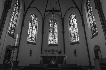 An altar in a catholic church with Jesus on the cross, black and white photo