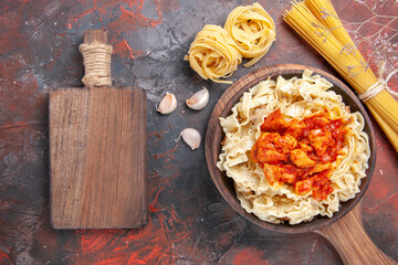 Wall Mural - top view chicken with dough pasta dish on dark floor dark pasta dish dough