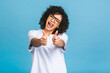 © denis_vermenko - Young African American black woman isolated on blue background giving a thumbs up gesture.