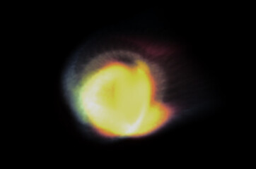 Wall Mural - coloured optical lens flare on black background.