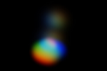 Wall Mural - coloured optical lens flare on black background.