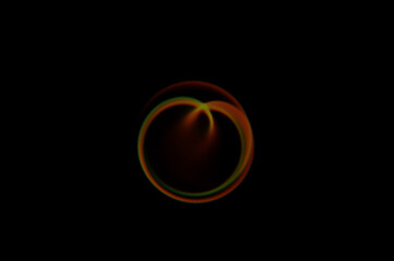Wall Mural - coloured optical lens flare on black background.