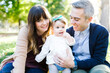 © Jessica Peterson/Tetra Images - Portrait of parents with daughter (12-17 months) in park