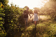 © Andriy Medvediuk - Beautiful couple having fun in sunflowers field. A man and a woman in love walk in a field with sunflowers, a man hugs a woman. selective focus