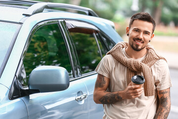 Canvas Print - Handsome man with coffee to-go near modern car